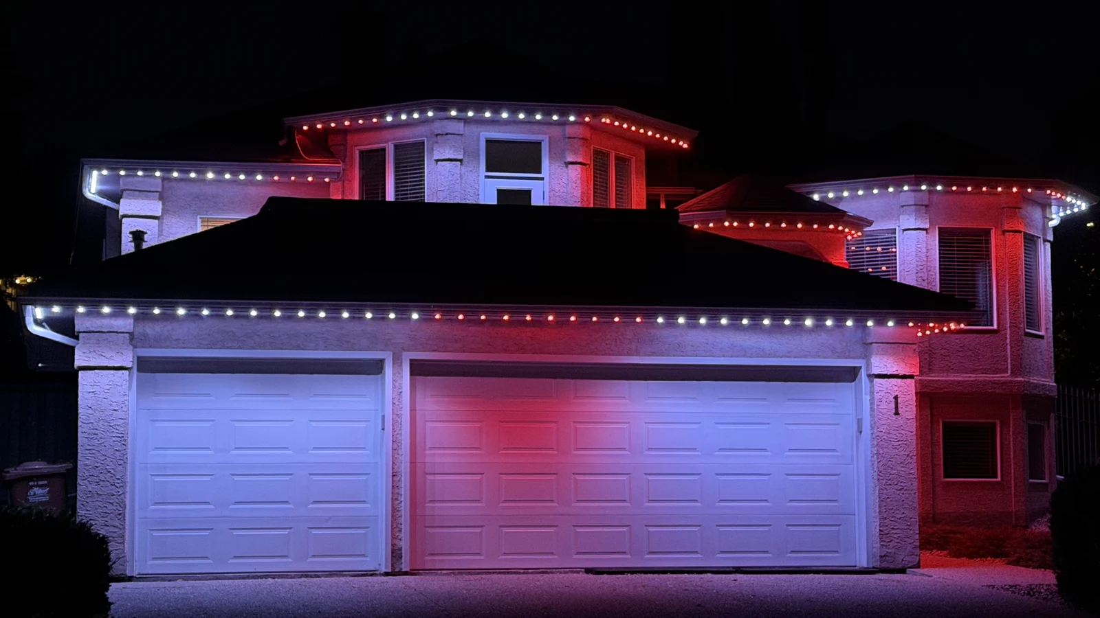 Red-and-white permanent roofline lighting for Canada Day