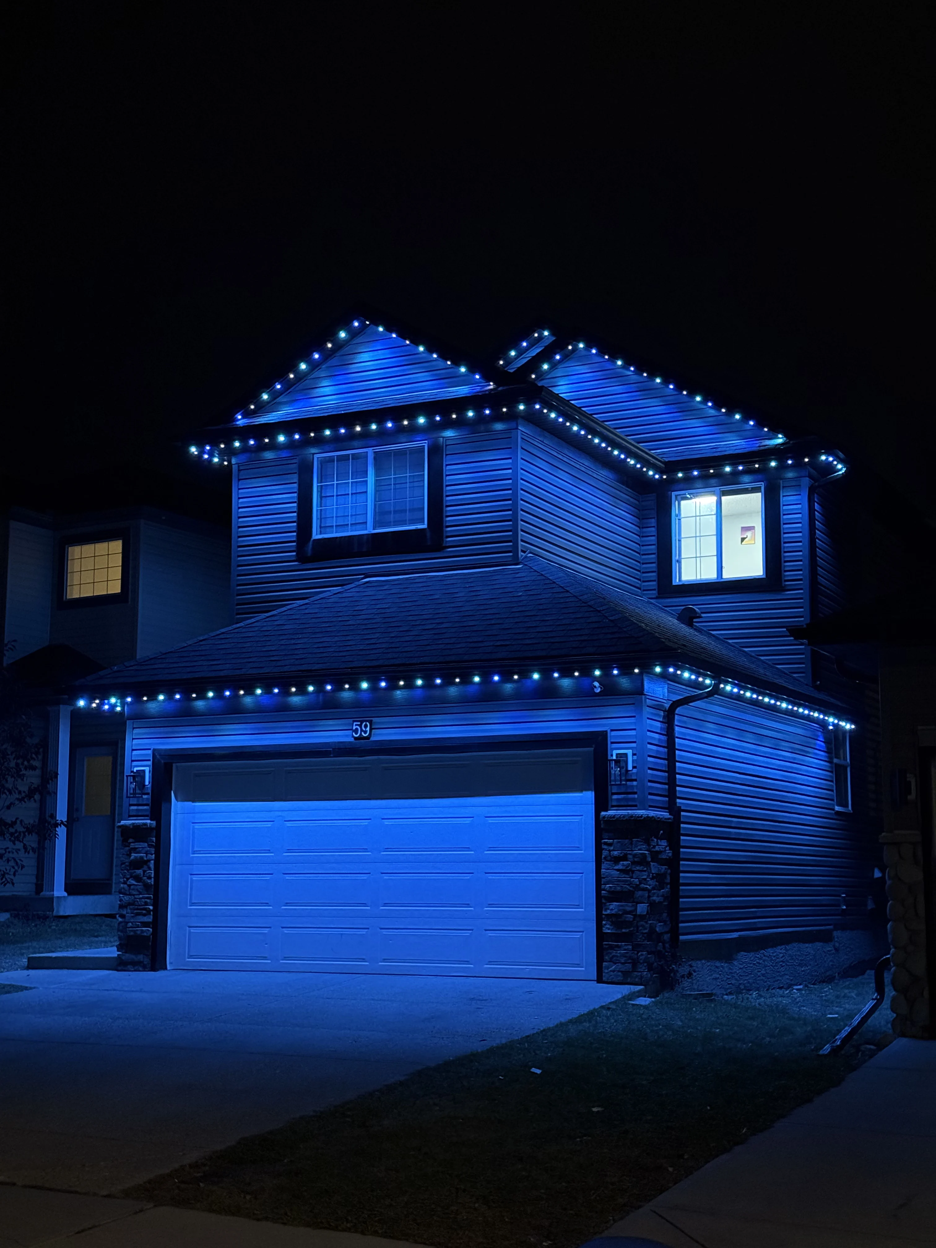 Permanent roofline lighting displayed on a Nanaimo home at night