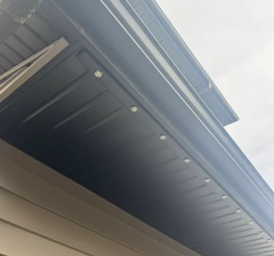 Prairie Lighting LED pixels fitted into black aluminum track beneath a home's soffit
